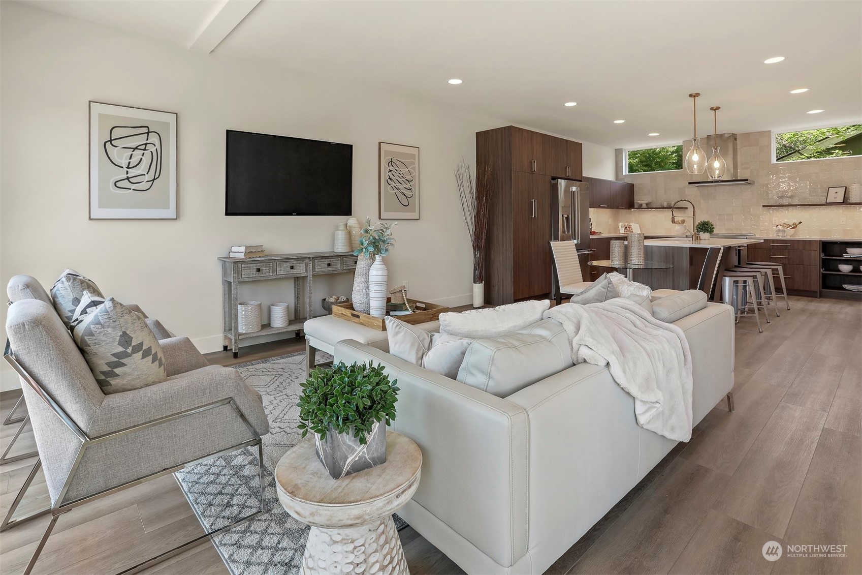 520 North 48th Street, Unit B Seattle, WA 98103 - Photo 7 of 38 a living room with furniture a flat screen tv and kitchen view