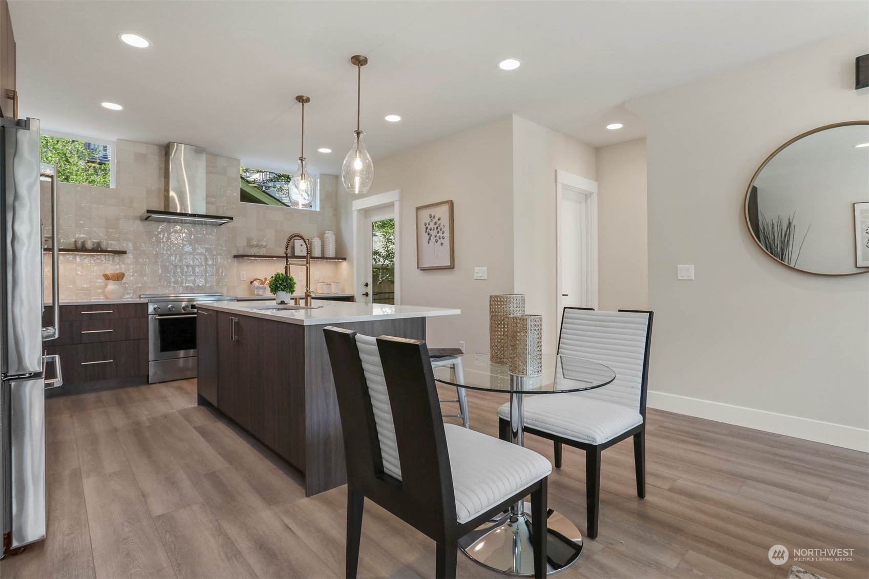 520 North 48th Street, Unit B Seattle, WA 98103 - Photo 9 of 38 a kitchen with stainless steel appliances kitchen island granite countertop a stove a sink and a refrigerator