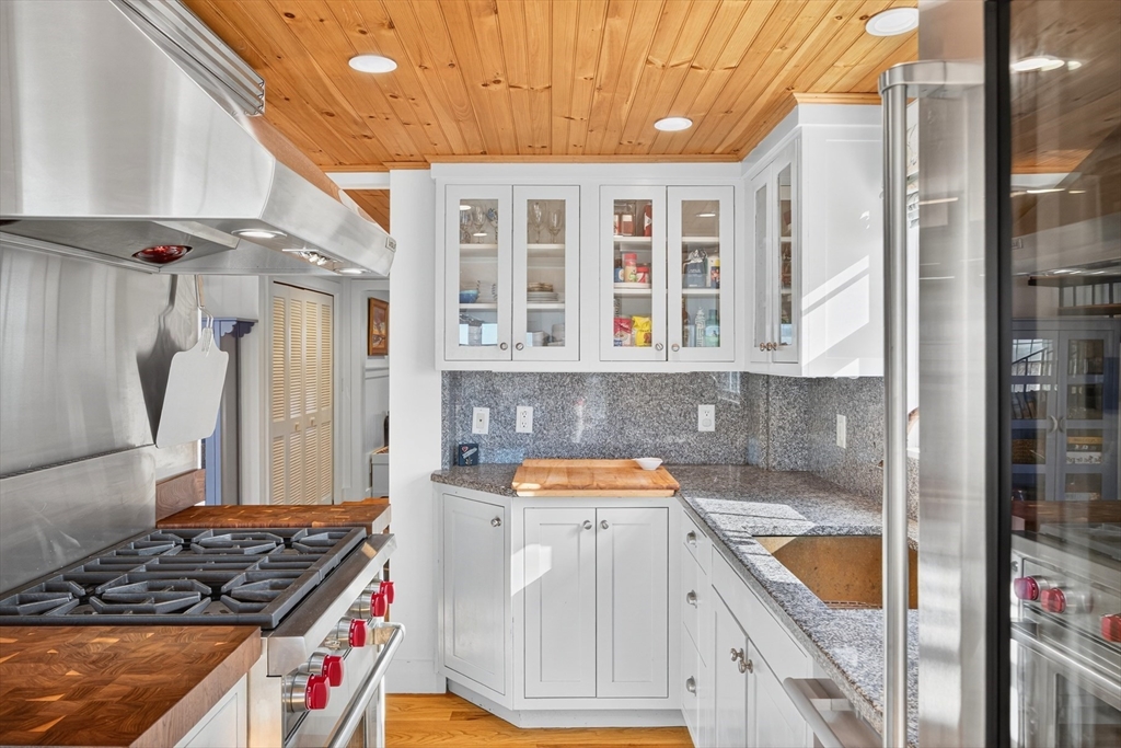 1145 Kingsbury Beach Road Eastham, MA 02642 - Photo 16 of 42 a kitchen with a stove and a refrigerator