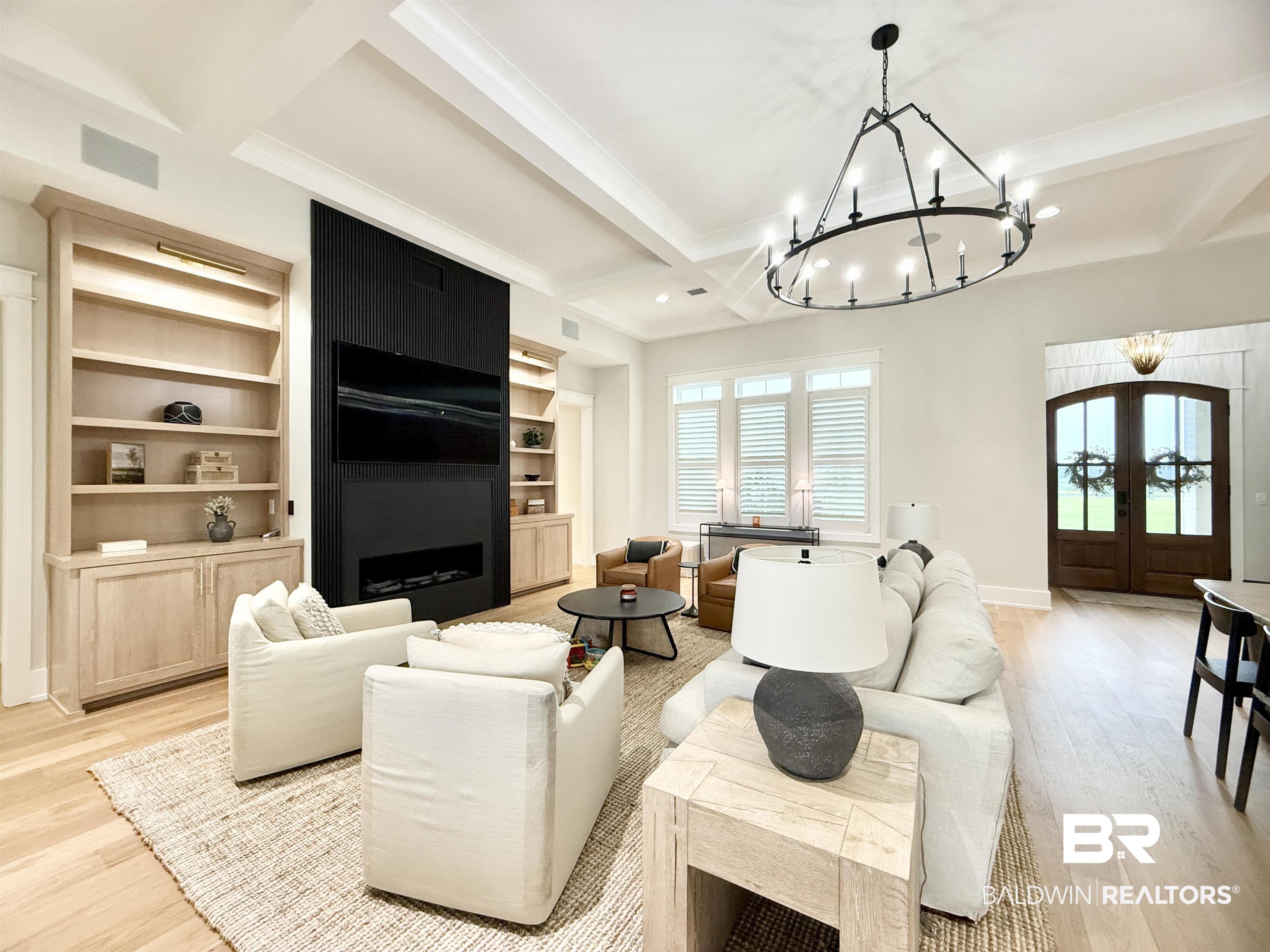 21767 Gallery Boulevard Fairhope, AL 36532 - Photo 20 of 74 Living room with a chandelier, beam ceiling, light wood-style flooring, french doors, and healthy amount of natural light