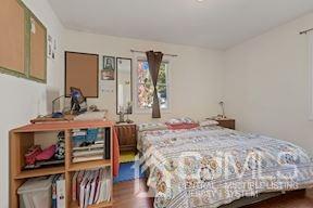 39 Morningside Road Colonia, NJ 07067 - Photo 24 of 30 a bedroom with a bed a dresser and wooden floor