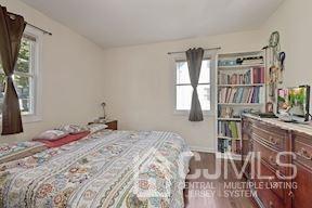 39 Morningside Road Colonia, NJ 07067 - Photo 26 of 30 a bedroom with a large bed and a flat tv screen