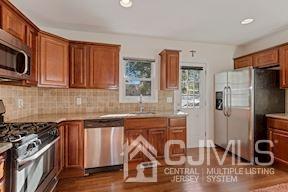39 Morningside Road Colonia, NJ 07067 - Photo 29 of 30 a kitchen with stainless steel appliances granite countertop a stove a sink and a microwave