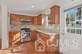 39 Morningside Road Colonia, NJ 07067 - Photo 30 of 30 a kitchen with stainless steel appliances granite countertop a stove top oven a sink a counter space and cabinets