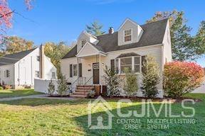 39 Morningside Road Colonia, NJ 07067 - Photo 4 of 30 a front view of a house with a garden and trees