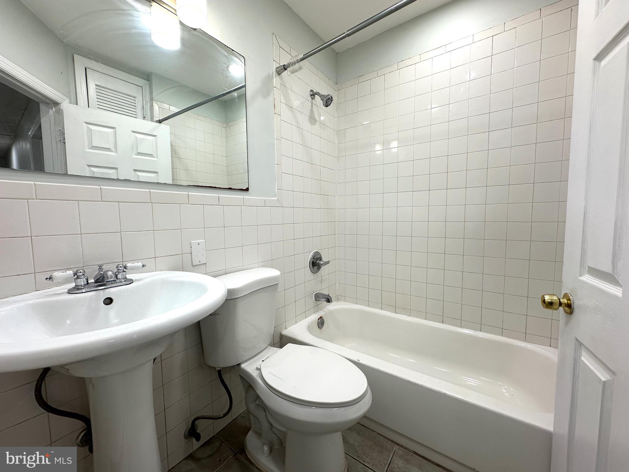 23 Lily Street Hamilton, NJ 08610 - Photo 3 of 10 a bathroom with a sink a toilet and bathtub