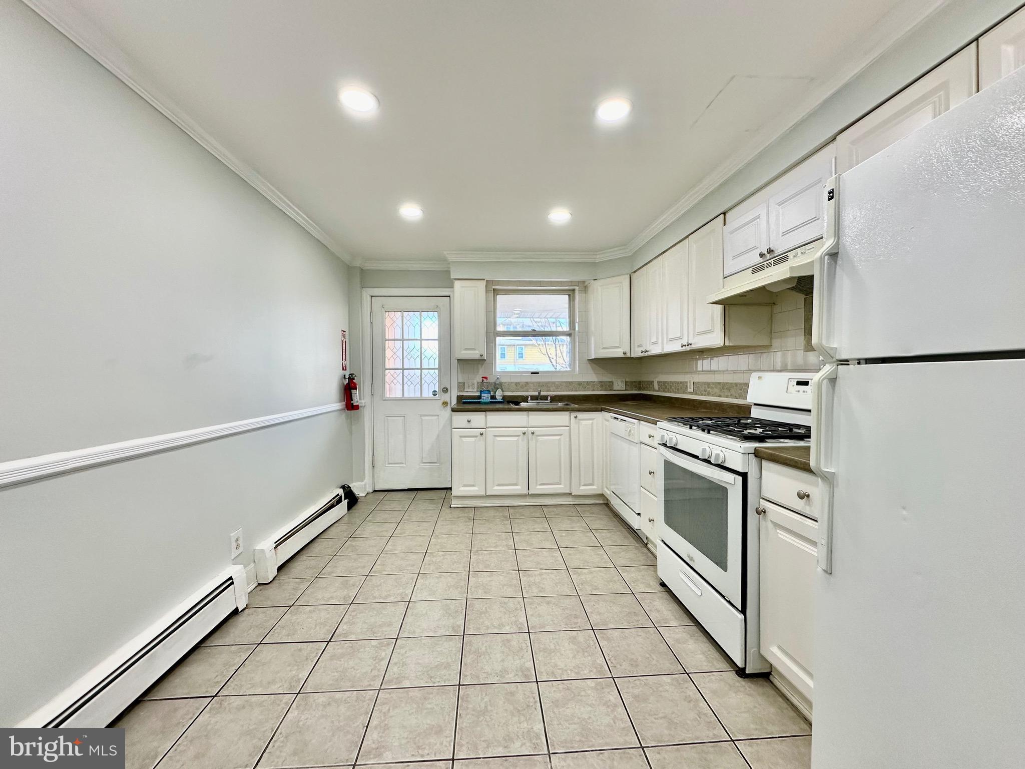 23 Lily Street Hamilton, NJ 08610 - Photo 8 of 10 a kitchen with stainless steel appliances granite countertop a refrigerator and a stove top oven