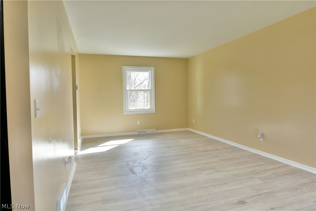 105 Fairview Avenue Cortland, OH 44410 - Photo 13 of 47 Spare room with light wood-style floors and baseboards