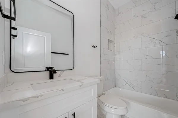 a bedroom with a bed a table and window