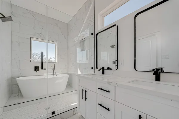 a bathroom with a double vanity sink and mirror