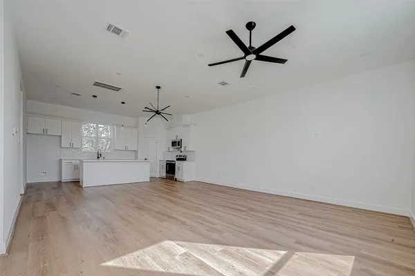 a view of a kitchen with a sink and cabinet with wooden floor