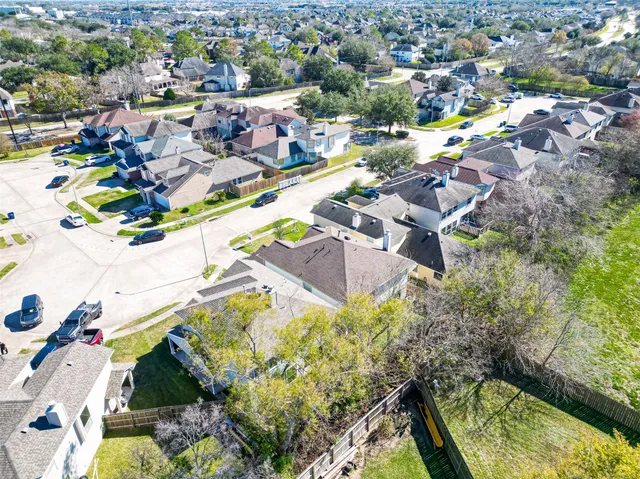 an aerial view of residential houses with outdoor space