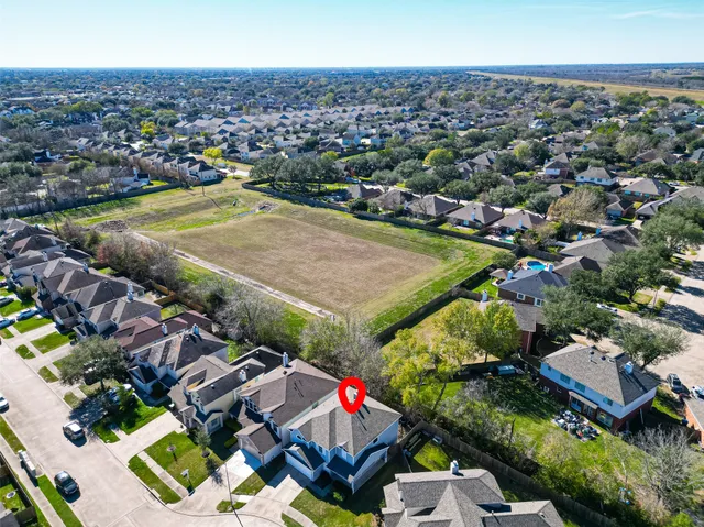an aerial view of a house with garden space and street view