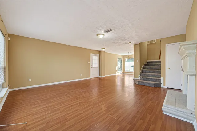 a view of a room with wooden floor and stairs