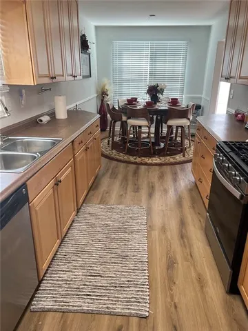 a kitchen with stainless steel appliances granite countertop a stove a sink and a microwave