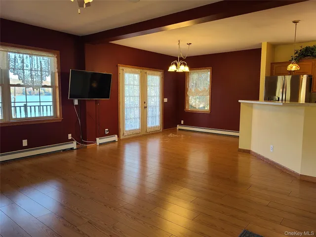 a kitchen with stainless steel appliances kitchen island granite countertop a refrigerator a stove top oven a sink and dishwasher