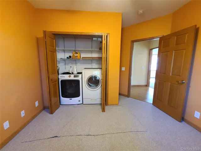 an aerial view of a house with a yard and lake view