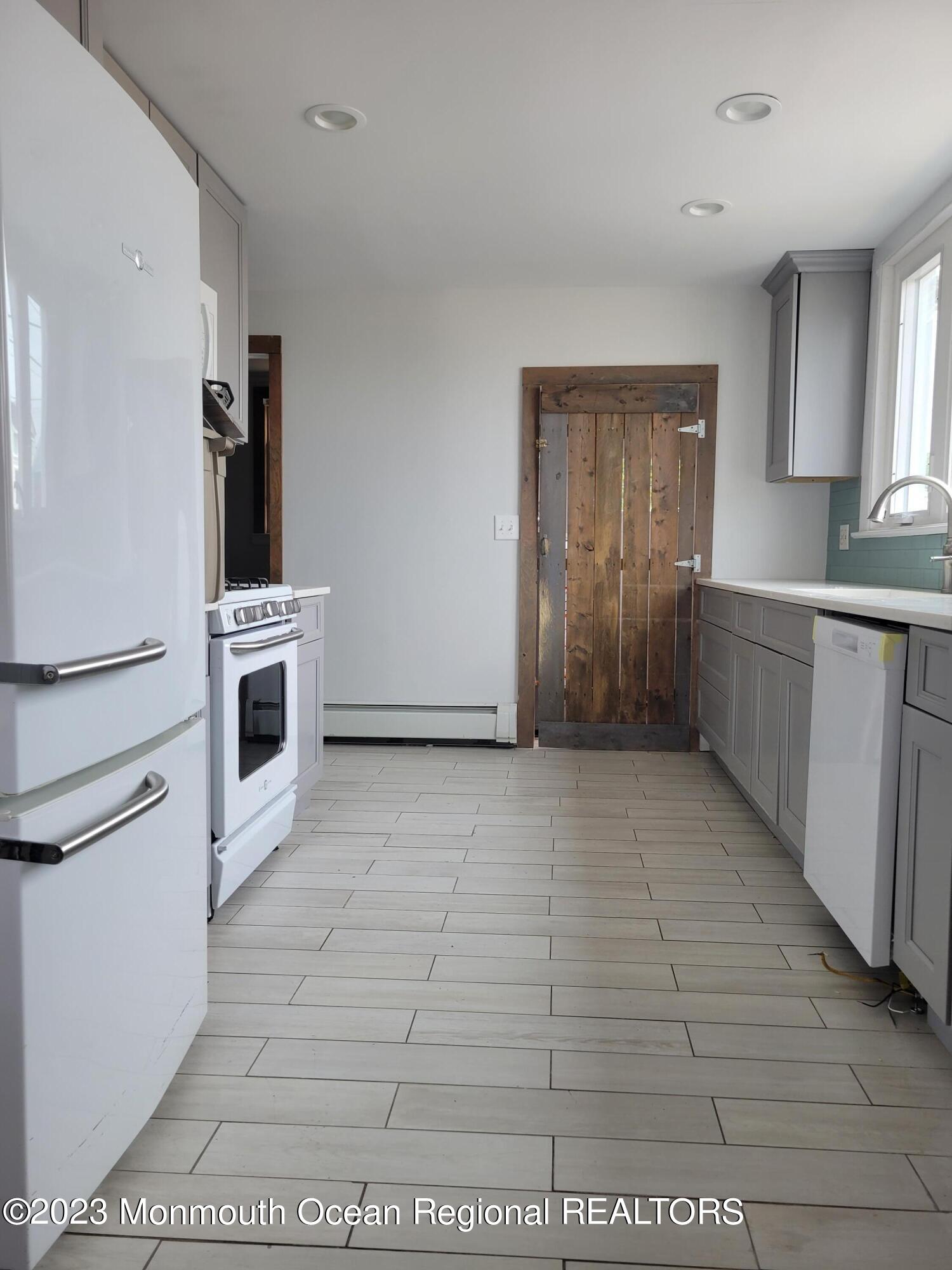 16 Cornwall Street Highlands, NJ 07732 - Photo 13 of 19 a kitchen with stainless steel appliances granite countertop a refrigerator and a stove