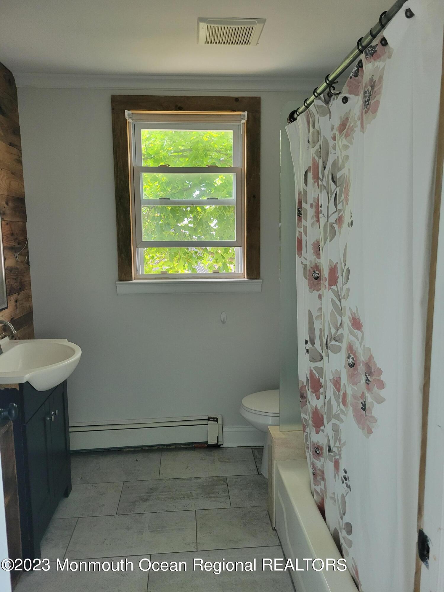 16 Cornwall Street Highlands, NJ 07732 - Photo 14 of 19 a bathroom with a toilet and a shower curtain