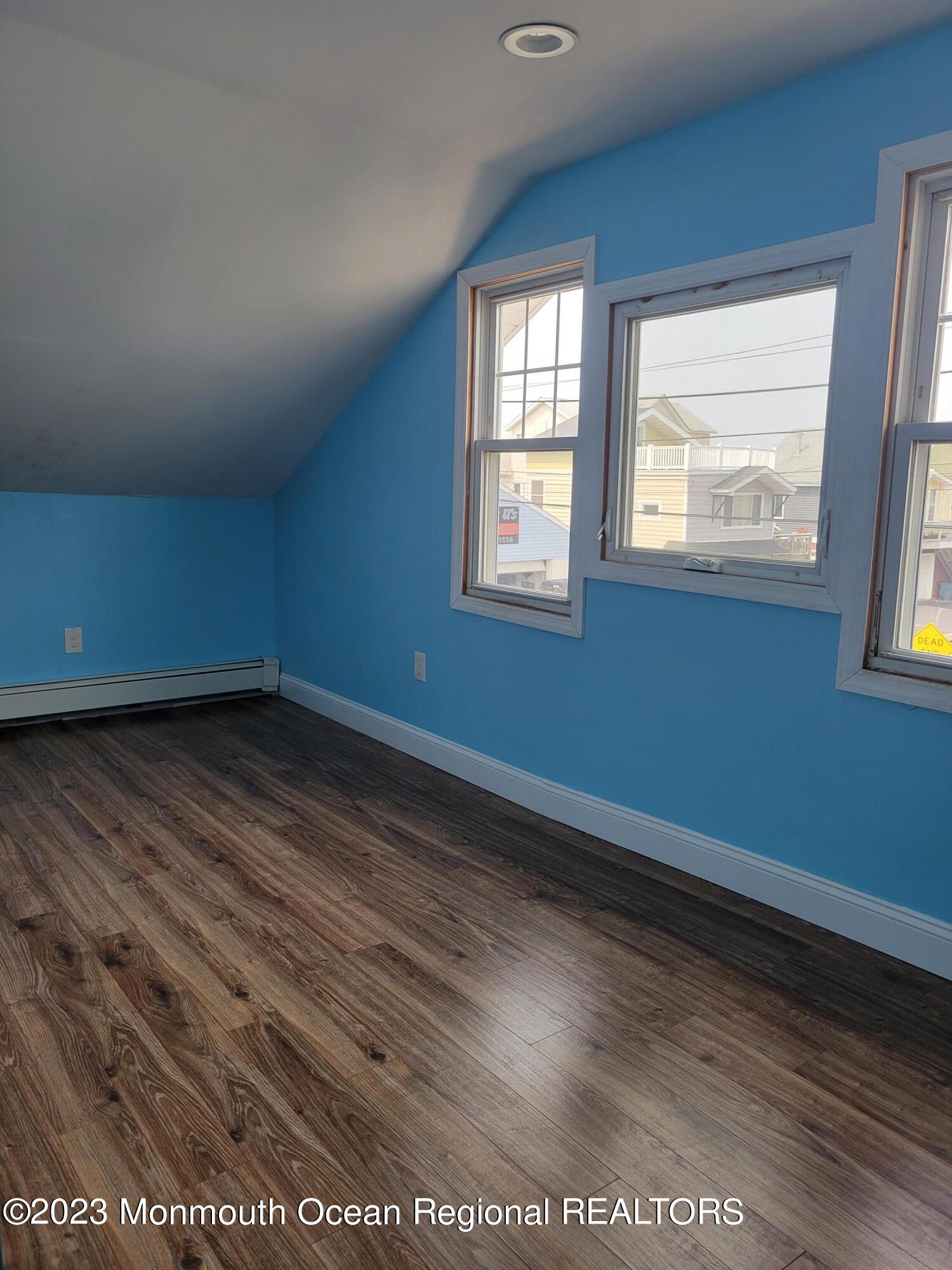 16 Cornwall Street Highlands, NJ 07732 - Photo 15 of 19 an empty room with wooden floor and windows