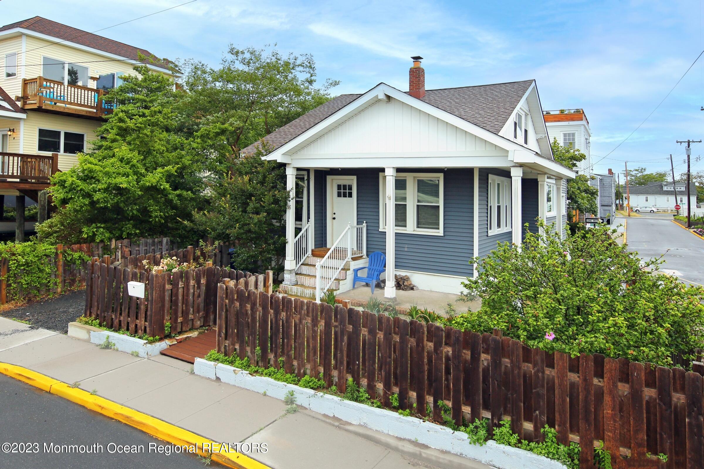 16 Cornwall Street Highlands, NJ 07732 - Photo 6 of 19 a view of a house with wooden fence next to a road