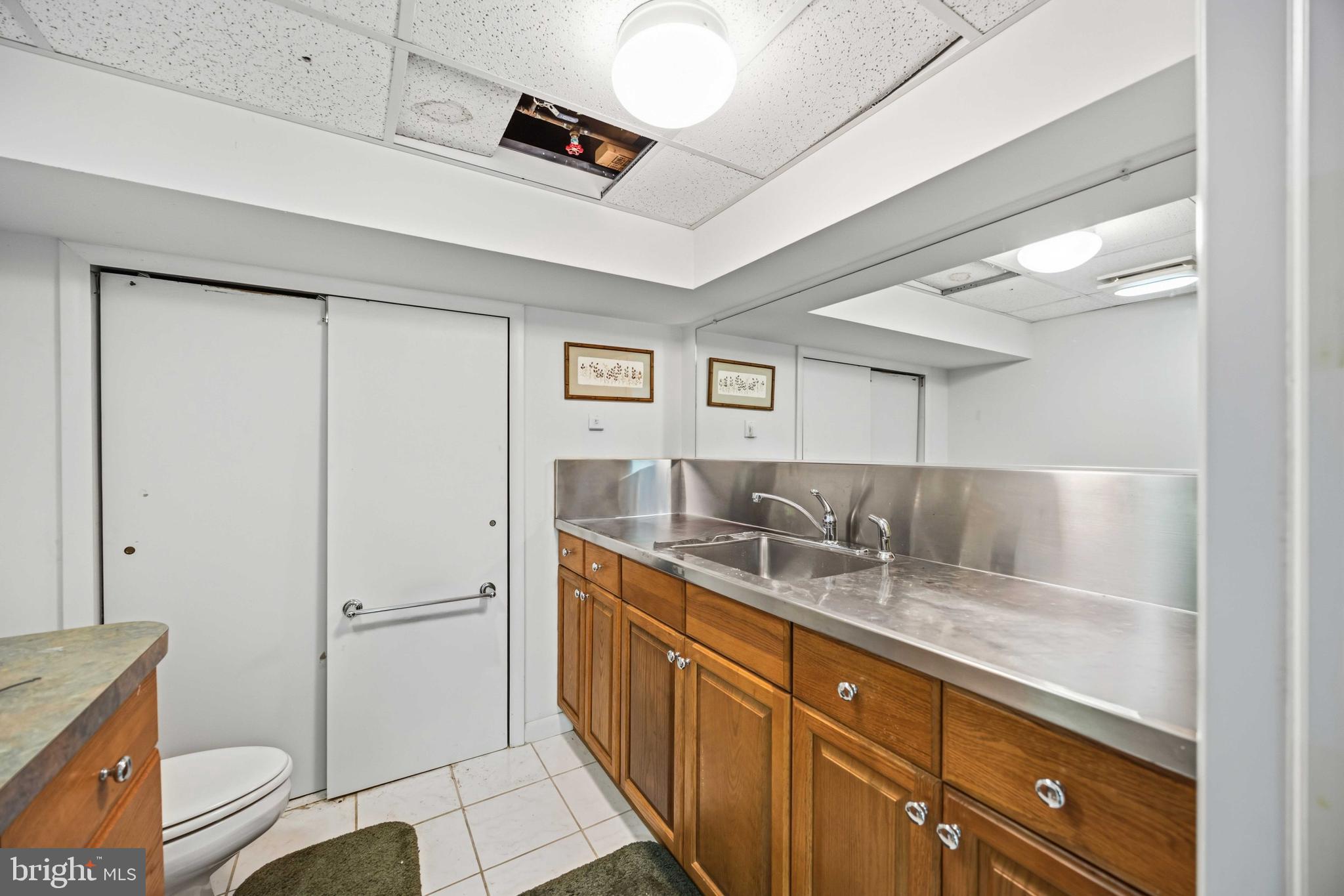 330 Bent Road Wyncote, PA 19095 - Photo 41 of 47 a bathroom with a granite countertop sink a mirror and a toilet