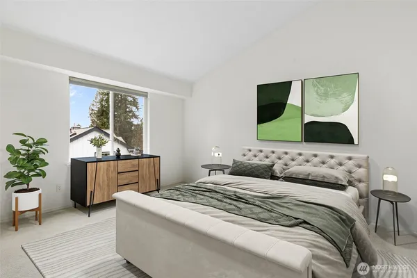 a bedroom with a bed and a potted plant