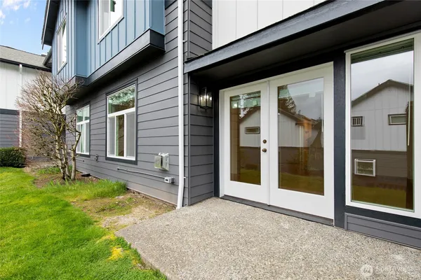 a view of a house with a porch and a yard
