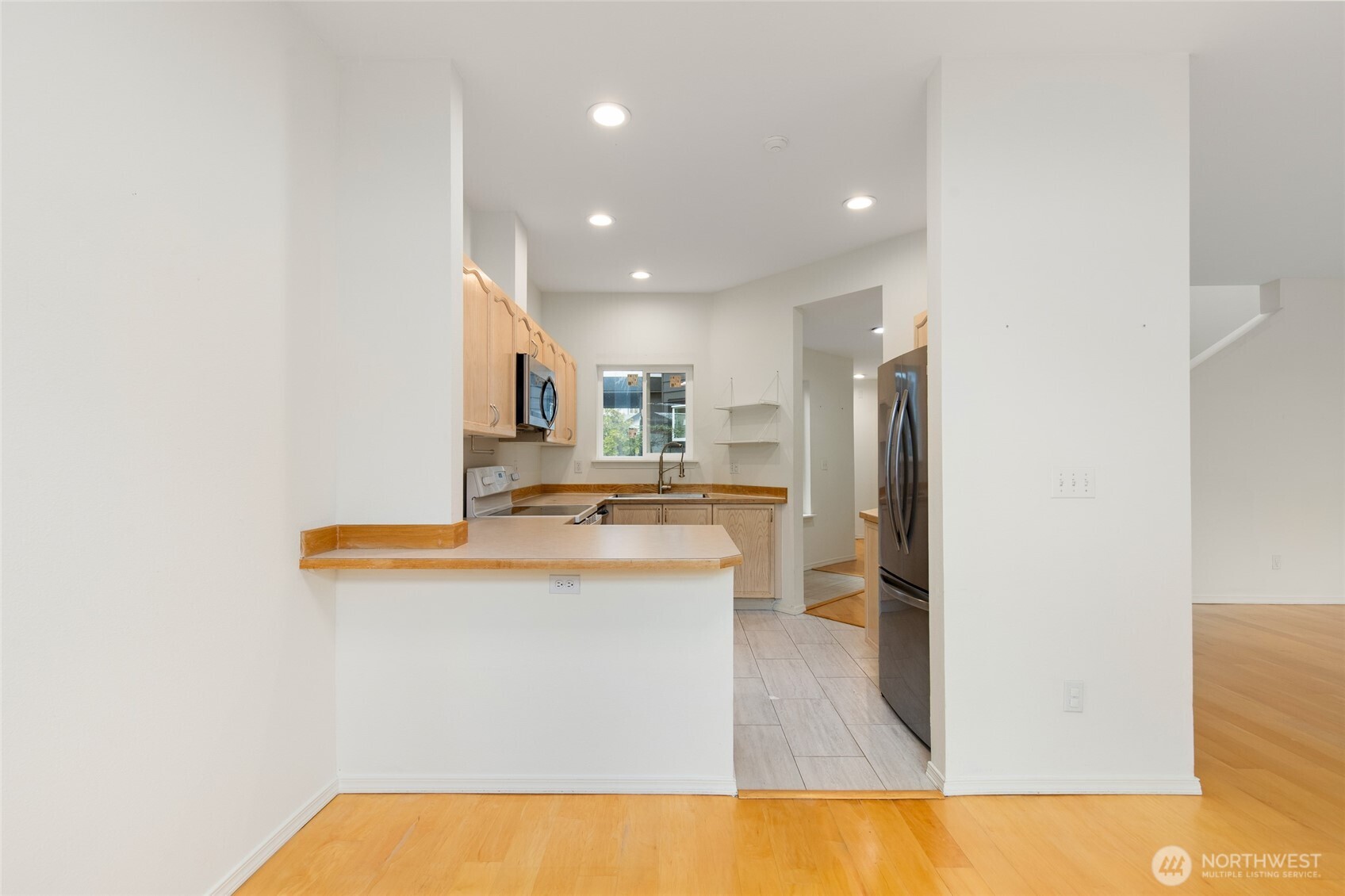 22619 4th Avenue West, Unit 3103 Bothell, WA 98021 - Photo 4 of 22 a kitchen with stainless steel appliances granite countertop a sink and a refrigerator