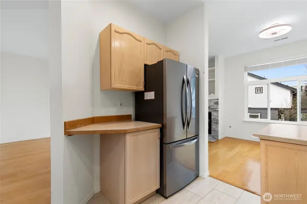 a utility room with refrigerator and a table