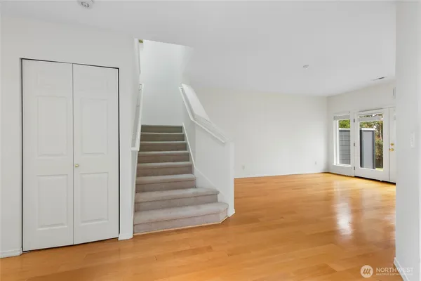 a view of an empty room with stairs and ventilation