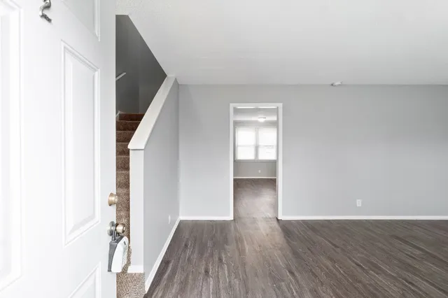a view of hallway with wooden floor