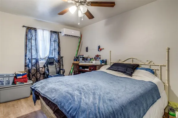 a bedroom with a bed and a chandelier