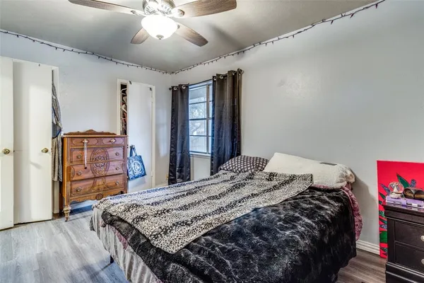a bedroom with a bed and a dresser