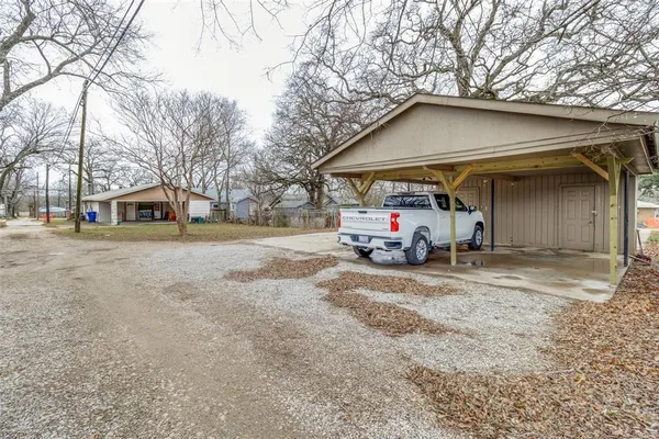 a car parked in front of white house