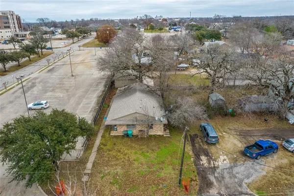 an aerial view of a house with a yard