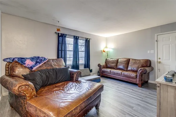 a living room with furniture window and a wooden floor