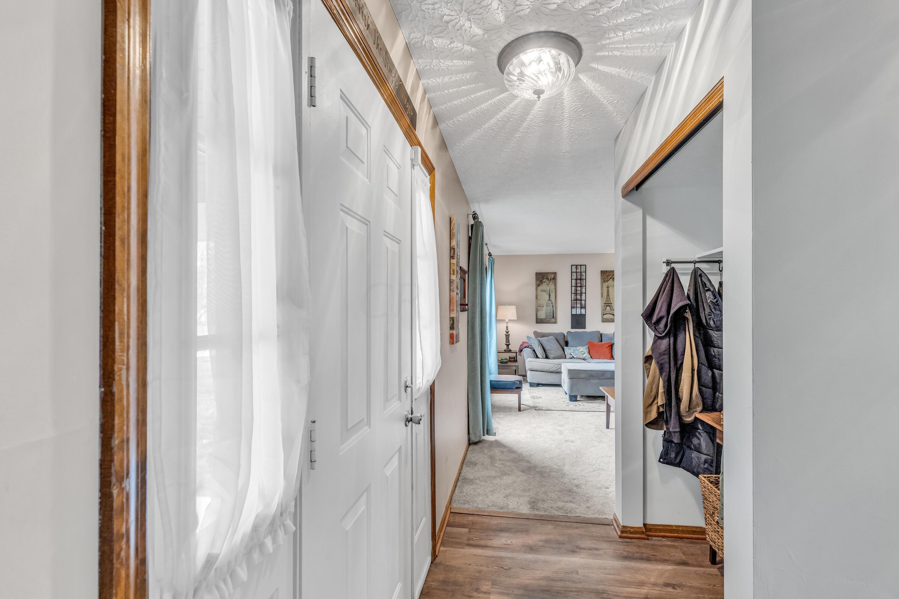 435 Emory Street Gahanna, OH 43230 - Photo 6 of 54 • New luxury vinyl plank
flooring ~ 2022
• Pale grey painted walls
• Side lights by front door
• New ceiling light ~ 2019