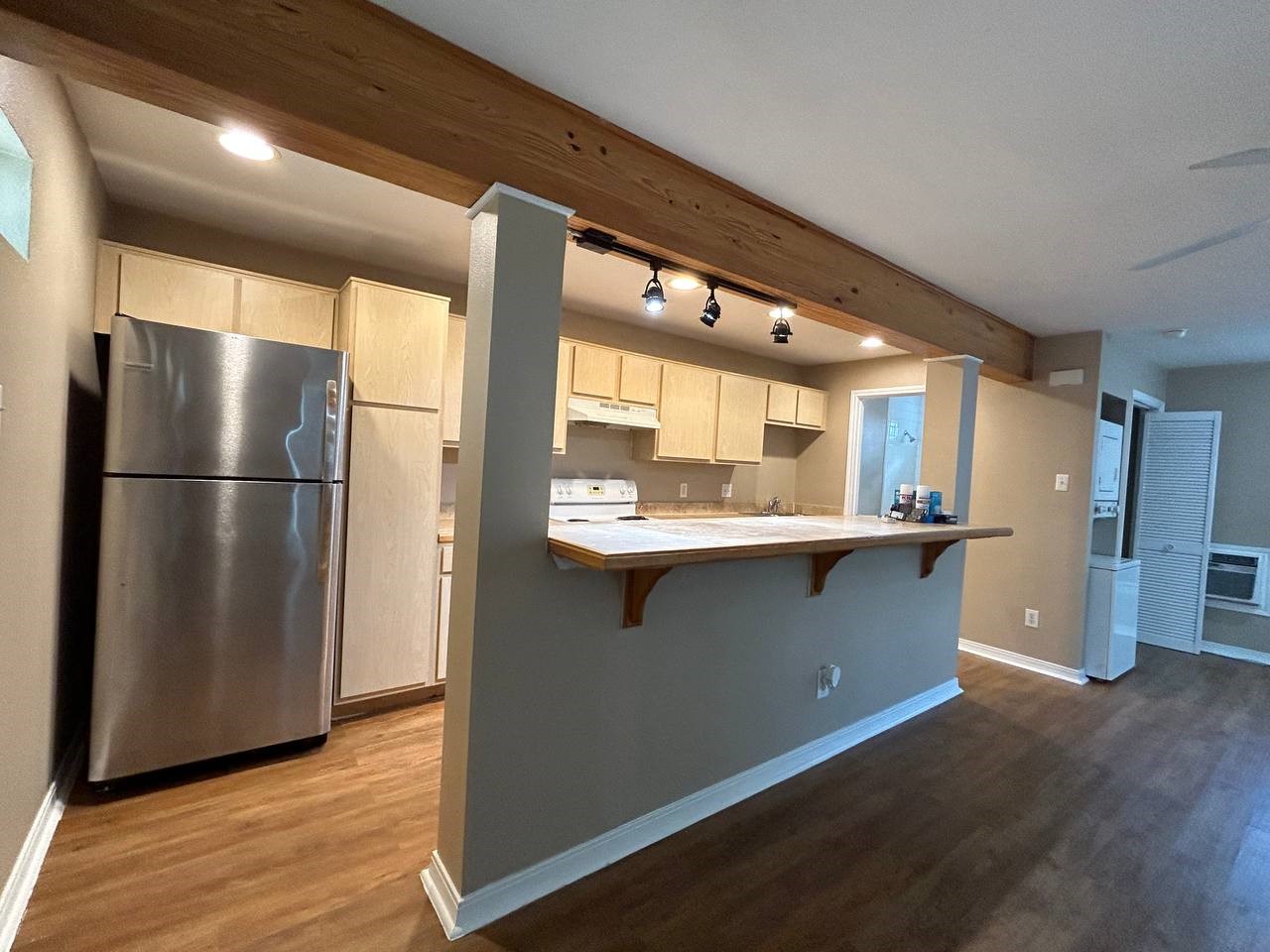 a kitchen with stainless steel appliances granite countertop a refrigerator and a sink