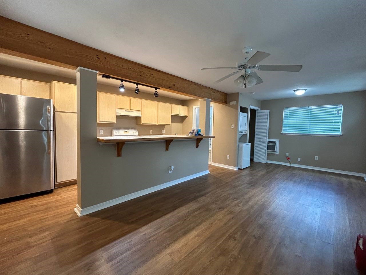 831 West 25th Street, Unit 7 Houston, TX 77008 - Photo 13 of 15 a view of a kitchen with a fridge and wooden floor