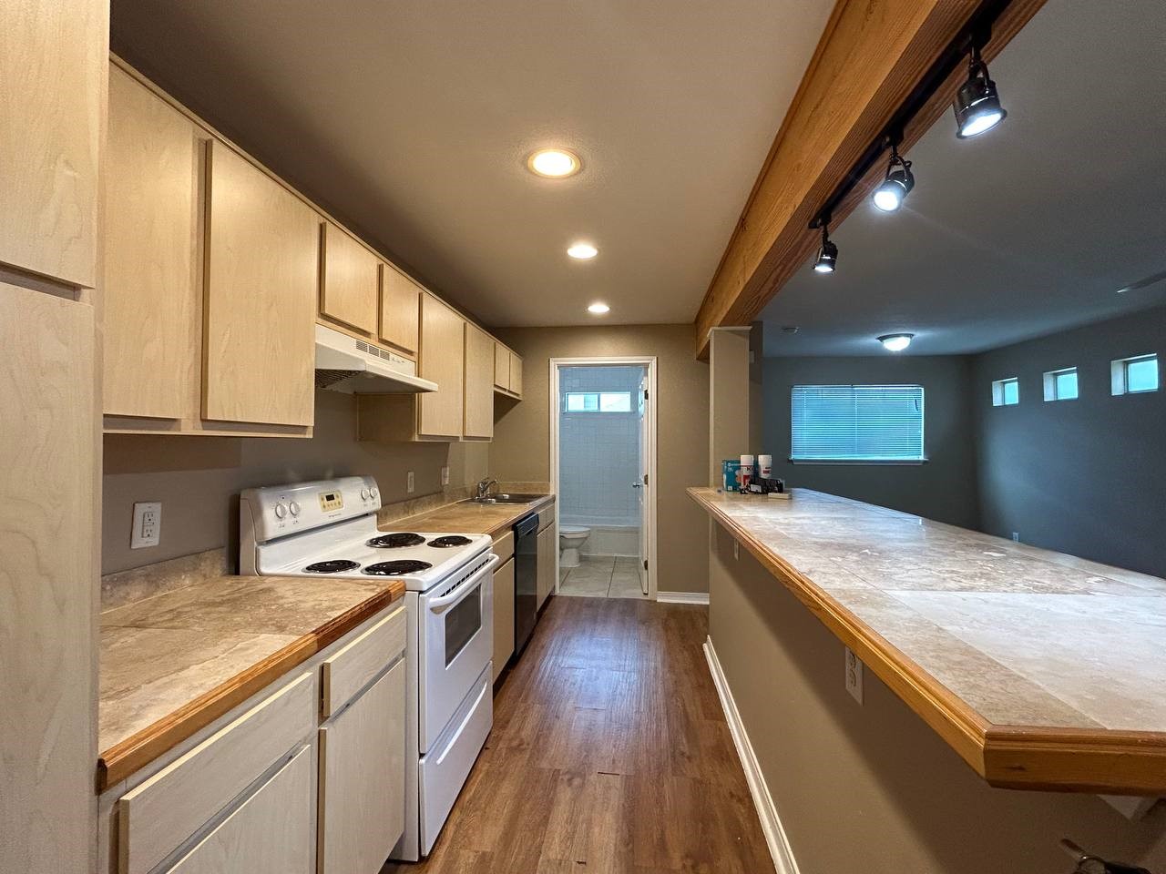 831 West 25th Street, Unit 7 Houston, TX 77008 - Photo 2 of 15 a large kitchen with stainless steel appliances granite countertop plenty wooden cabinets counter space and a sink