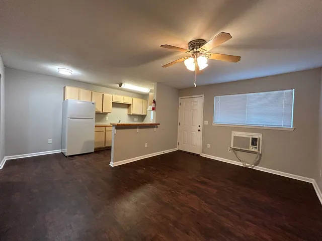 a view of a kitchen with a sink a ceiling fan and a kitchen view