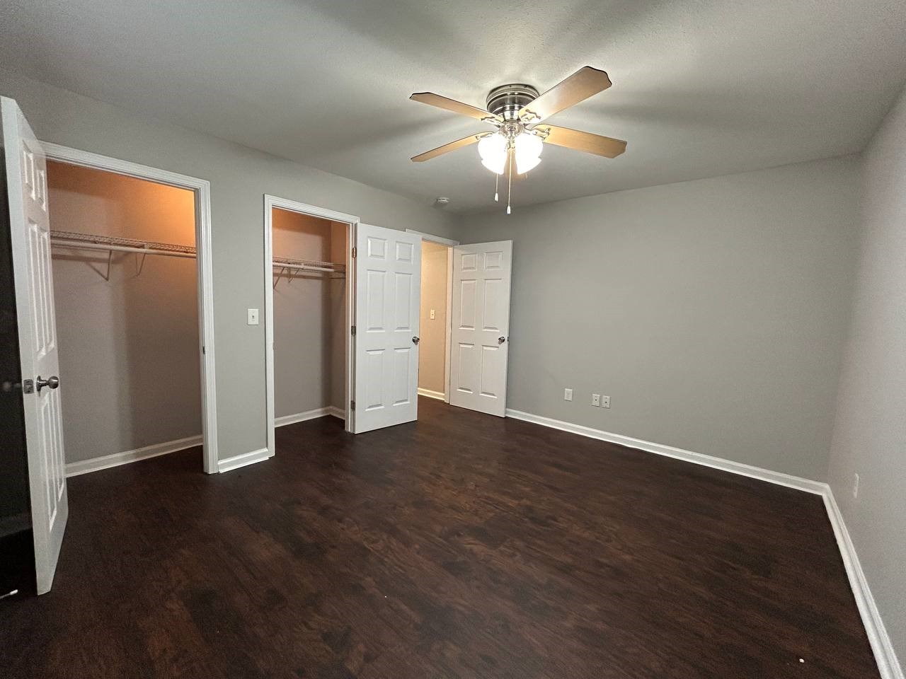 831 West 25th Street, Unit 7 Houston, TX 77008 - Photo 9 of 15 an empty room with wooden floor chandelier fan and windows