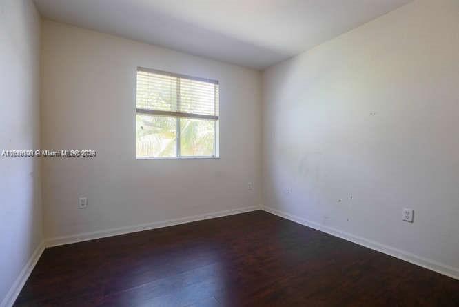 2911 Southeast 15th Road, Unit 65 Homestead, FL 33035 - Photo 11 of 11 an empty room with wooden floor and windows
