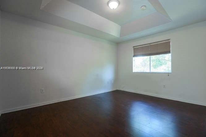 2911 Southeast 15th Road, Unit 65 Homestead, FL 33035 - Photo 6 of 11 an empty room with wooden floor and windows