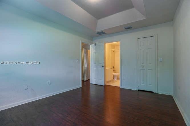 2911 Southeast 15th Road, Unit 65 Homestead, FL 33035 - Photo 7 of 11 a view of an empty room with wooden floor and a window
