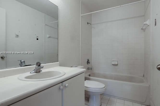 2911 Southeast 15th Road, Unit 65 Homestead, FL 33035 - Photo 8 of 11 a bathroom with a sink a toilet and shower