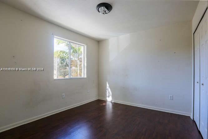 2911 Southeast 15th Road, Unit 65 Homestead, FL 33035 - Photo 9 of 11 an empty room with wooden floor and windows