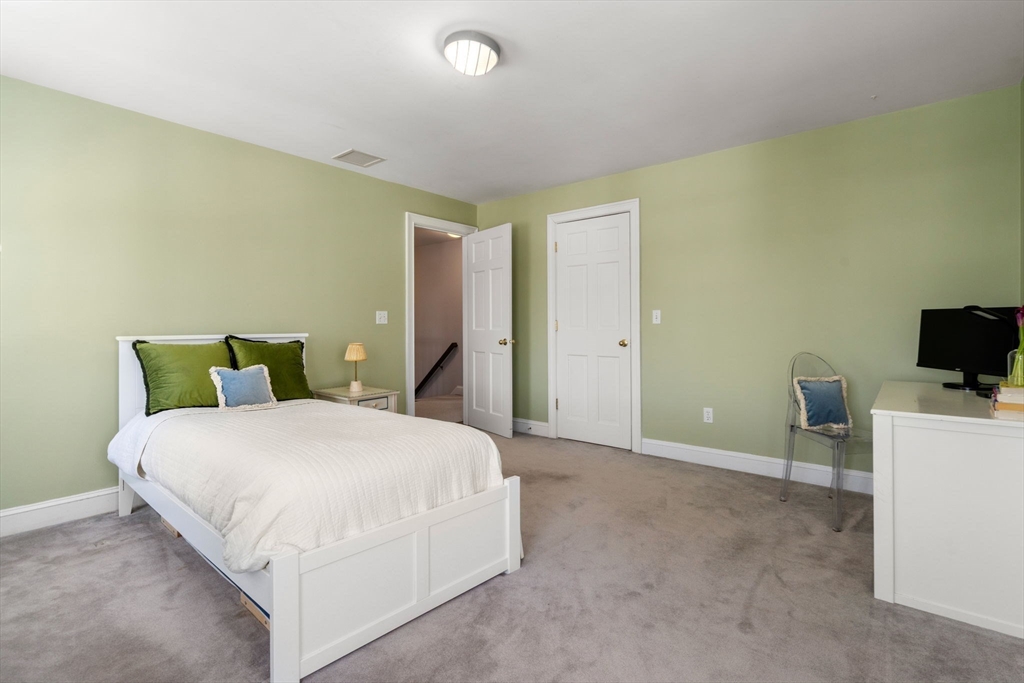 86 Whittier Road Wellesley, MA 02481 - Photo 26 of 39 a bedroom with a bed and a television
