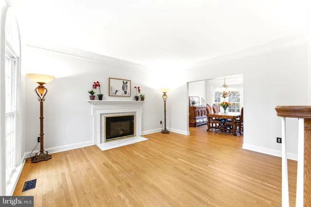 a kitchen with stainless steel appliances granite countertop a refrigerator a sink dishwasher a stove and white countertops with wooden floor